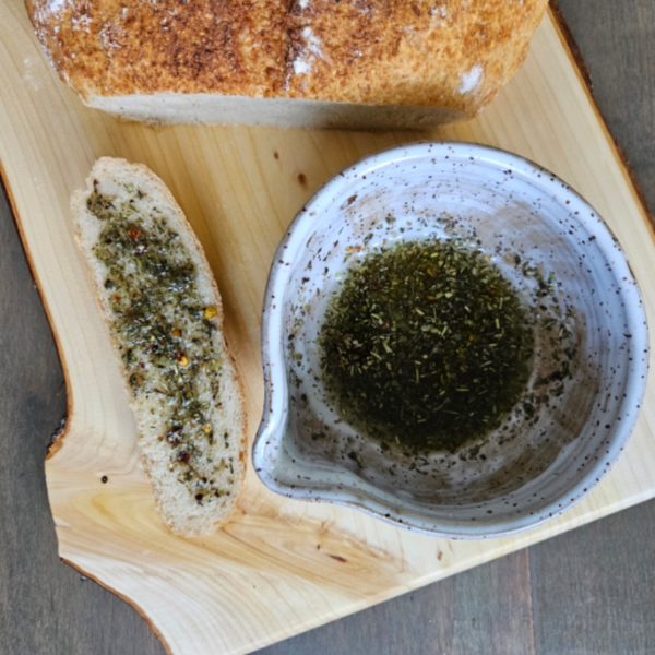 Sourdough On Handmade Homestead Wooden Cutting Board With Herbed Olive Oil In Marinade Pottery Bowl